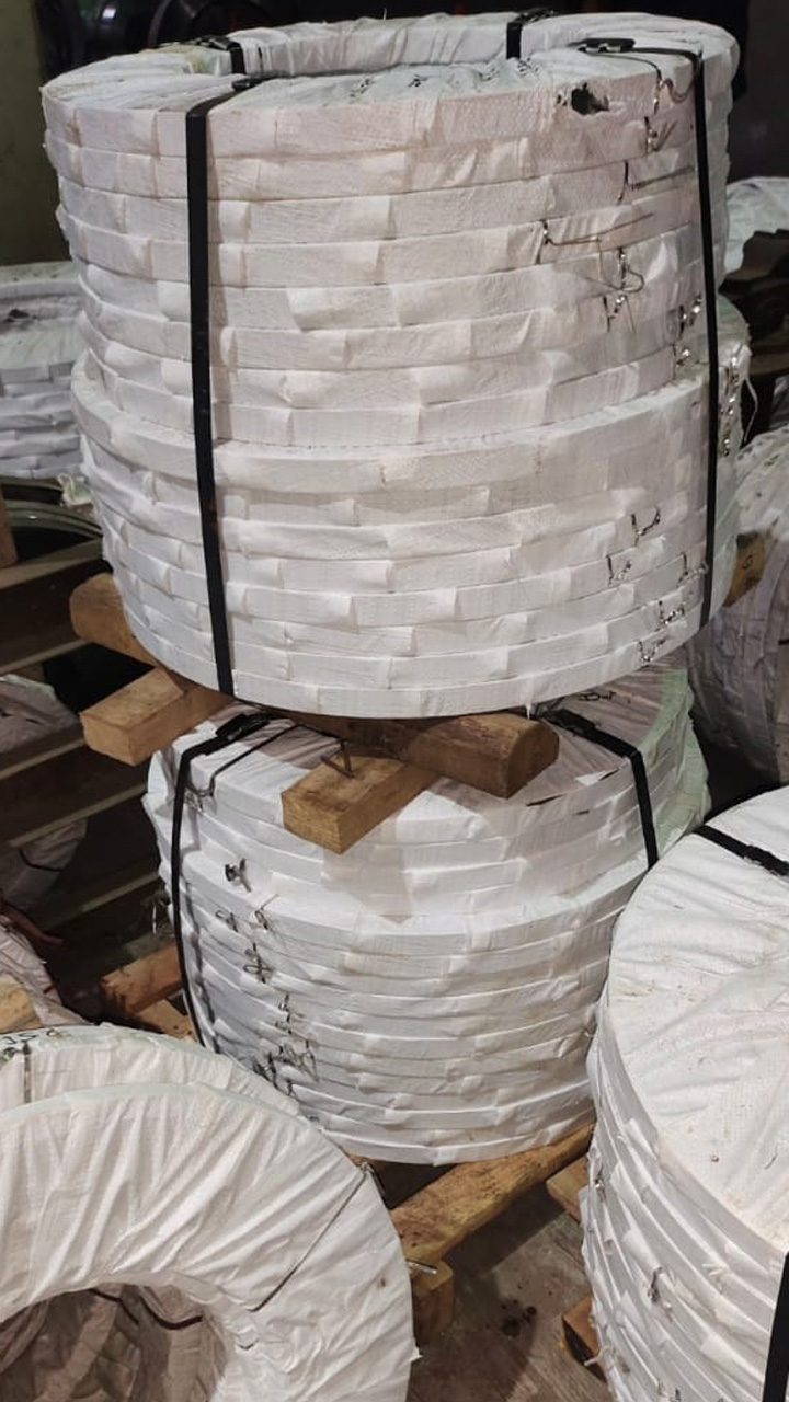 Finished strip coils wrapped, strapped and stacked on dunnage before dispatch