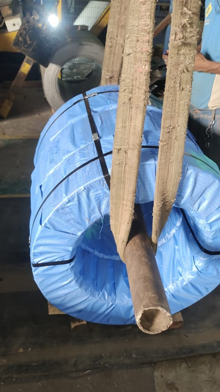 Wrapped coil lifted on webbing slings with a mandrel bar through the eye