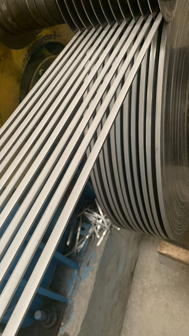 Slit stainless steel strips running from the separator onto the recoiler mandrel